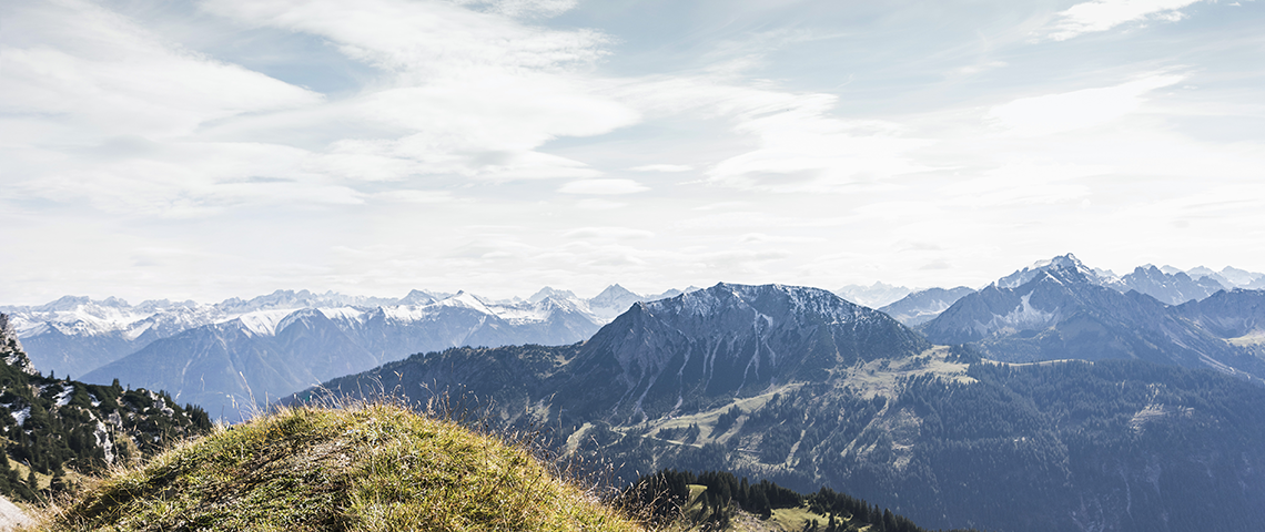 hands operating a compass on the horizon