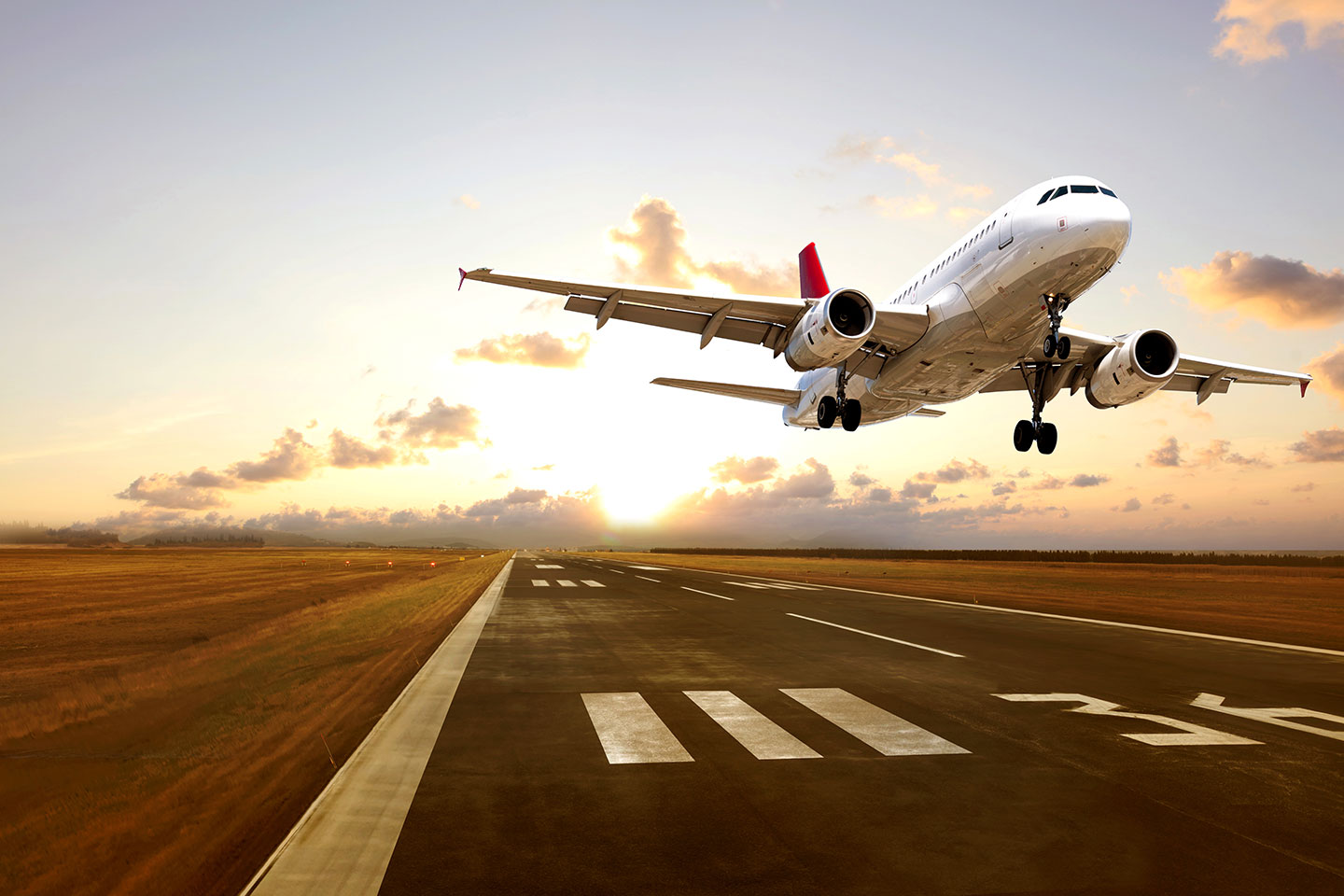 Airplane taking off into the sunset
